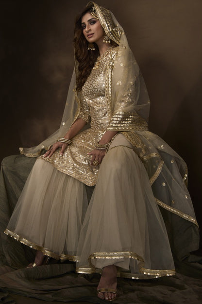 Dusty beige soft net sequence work ceremonial sharara salwar suit