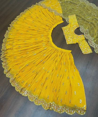 Yellow chinon silk embroidered pleated lehenga for haldi ceremony