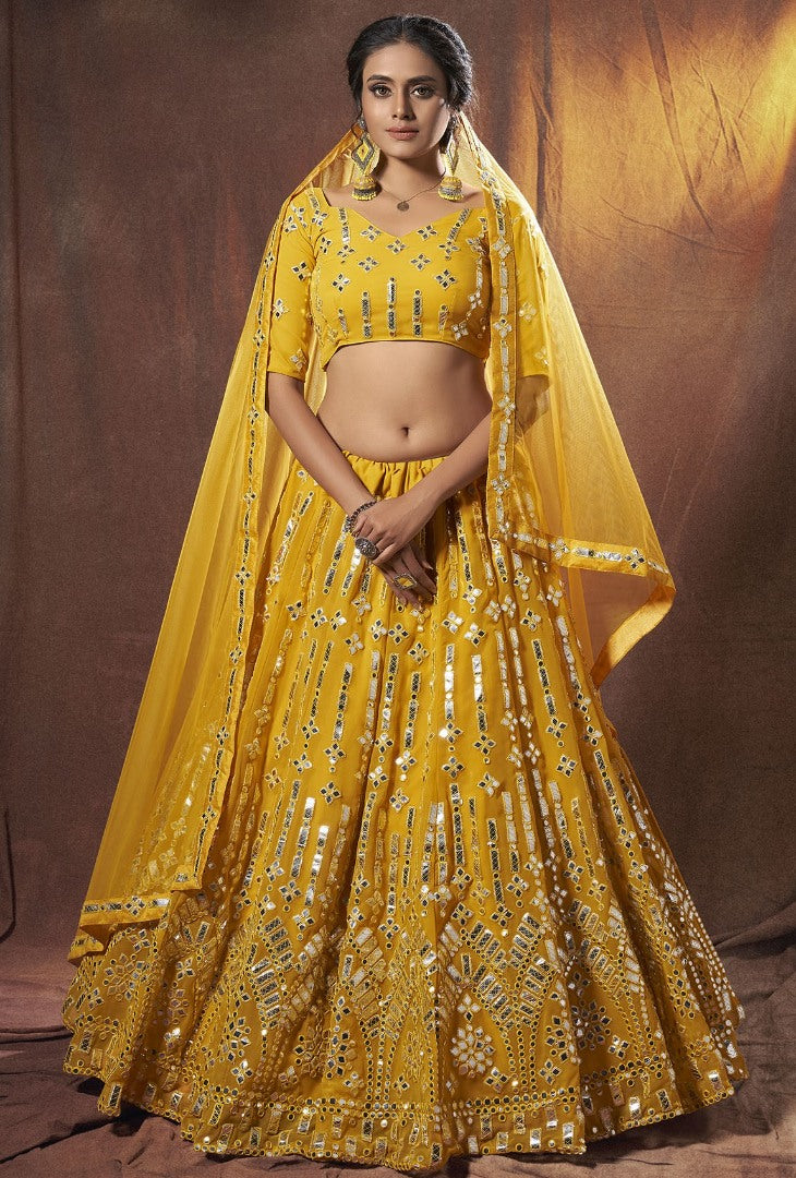 Yellow georgette soft net mirror work ceremonial lehenga choli