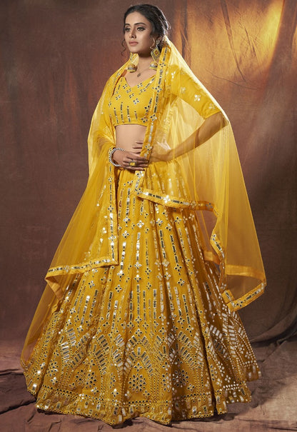 Yellow georgette soft net mirror work ceremonial lehenga choli