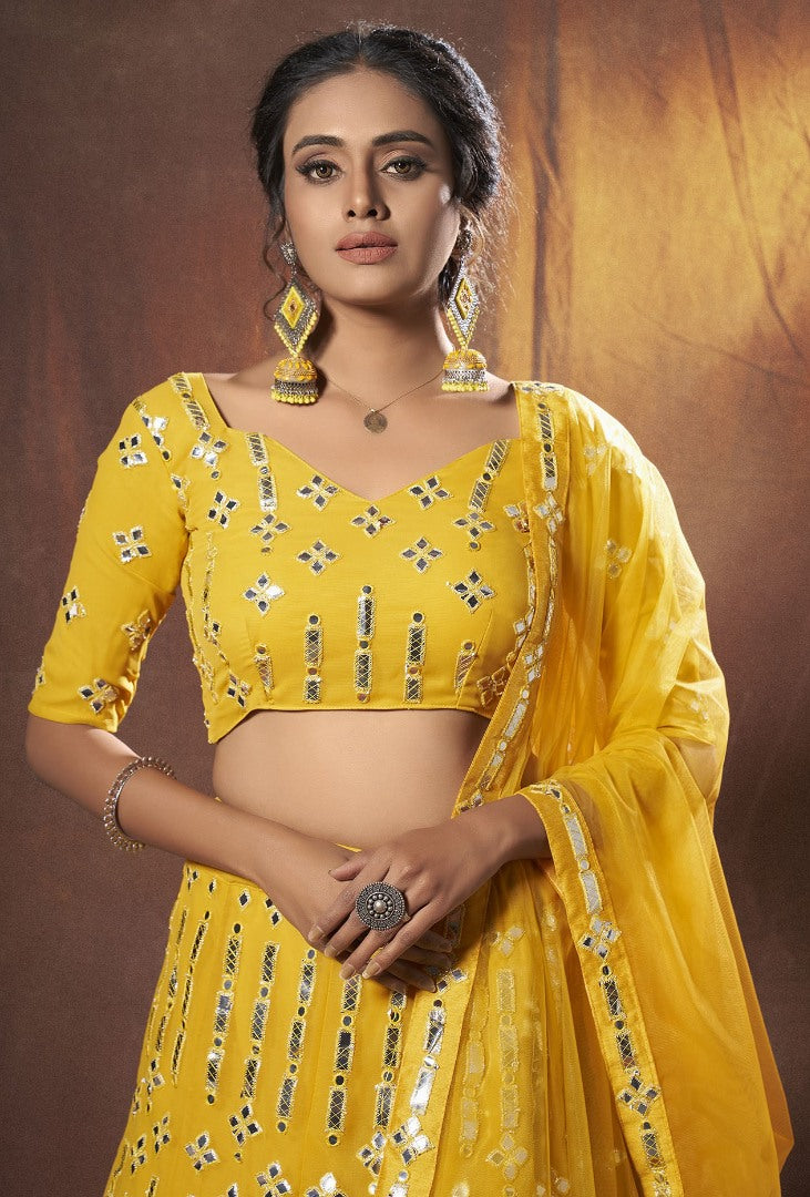 Yellow georgette soft net mirror work ceremonial lehenga choli