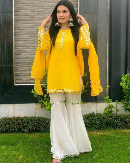 Yellow georgette top with white sharara salwar suit