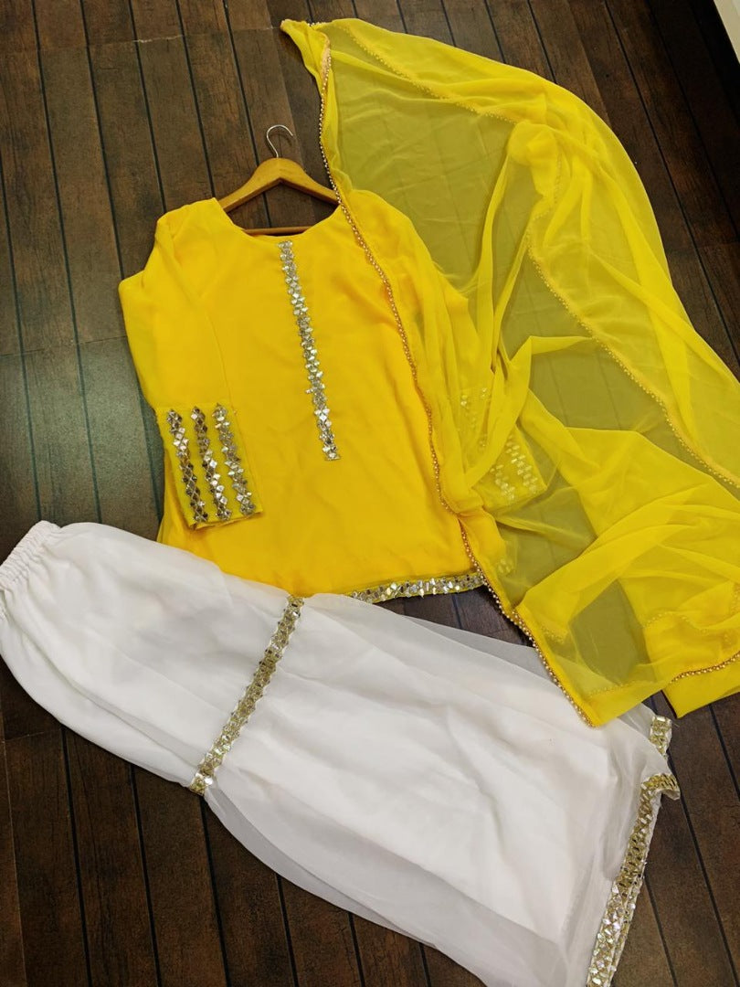 Yellow georgette top with white sharara salwar suit