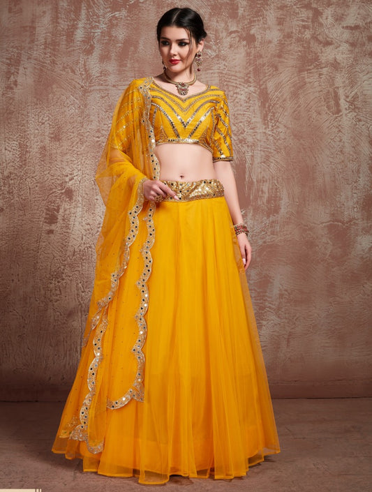 Yellow soft silk ceremonial lehenga choli with mirror work blouse