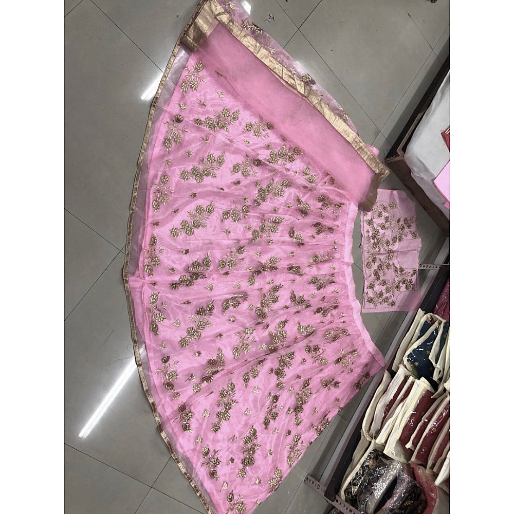 Pink net heavy embroidered wedding lehenga