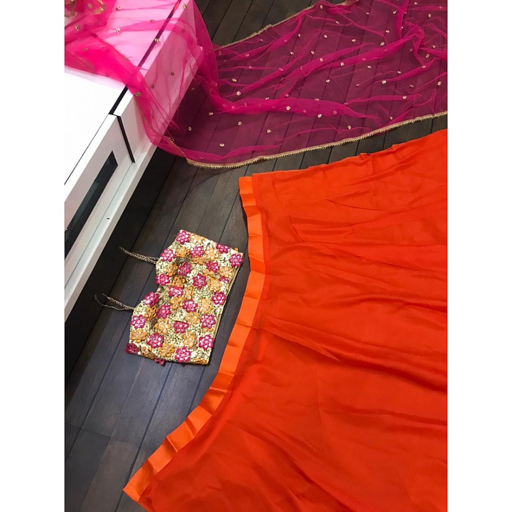 Orange ceremonial lehenga choli with heavy work blouse
