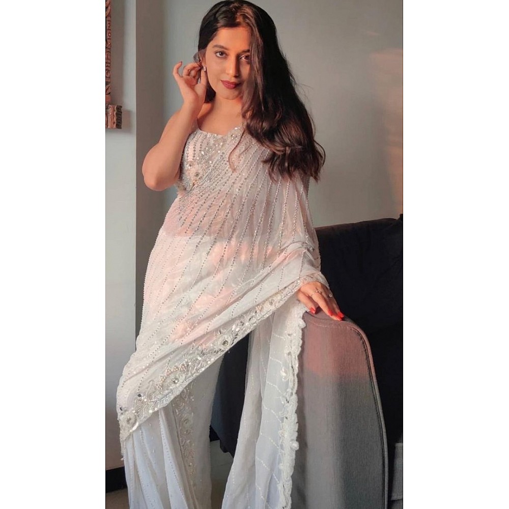 White organza silk zari embroidered and mirror work saree