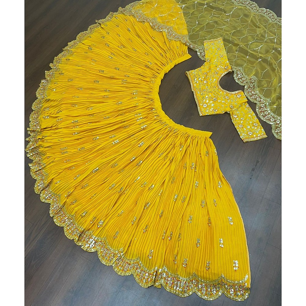 Yellow chinon silk embroidered pleated lehenga for haldi ceremony