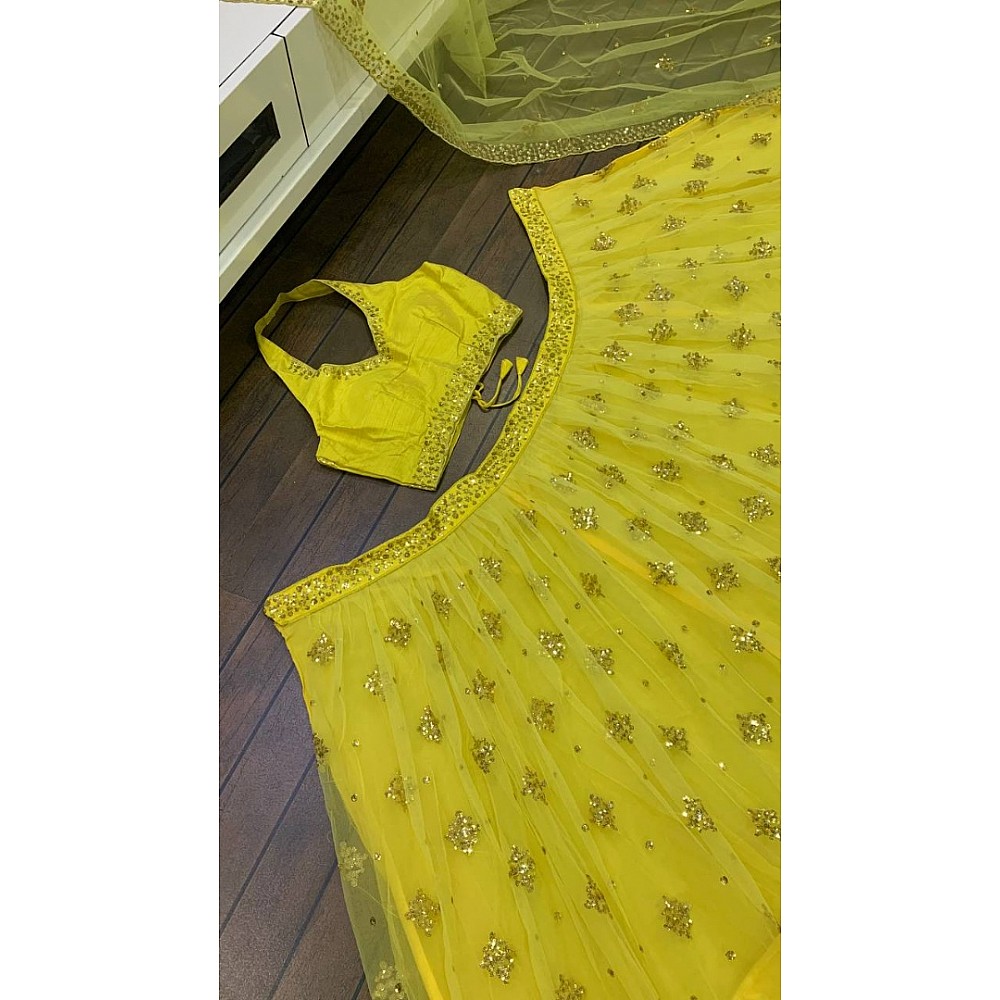 Yellow net embroidery work lehenga choli for haldi ceremony